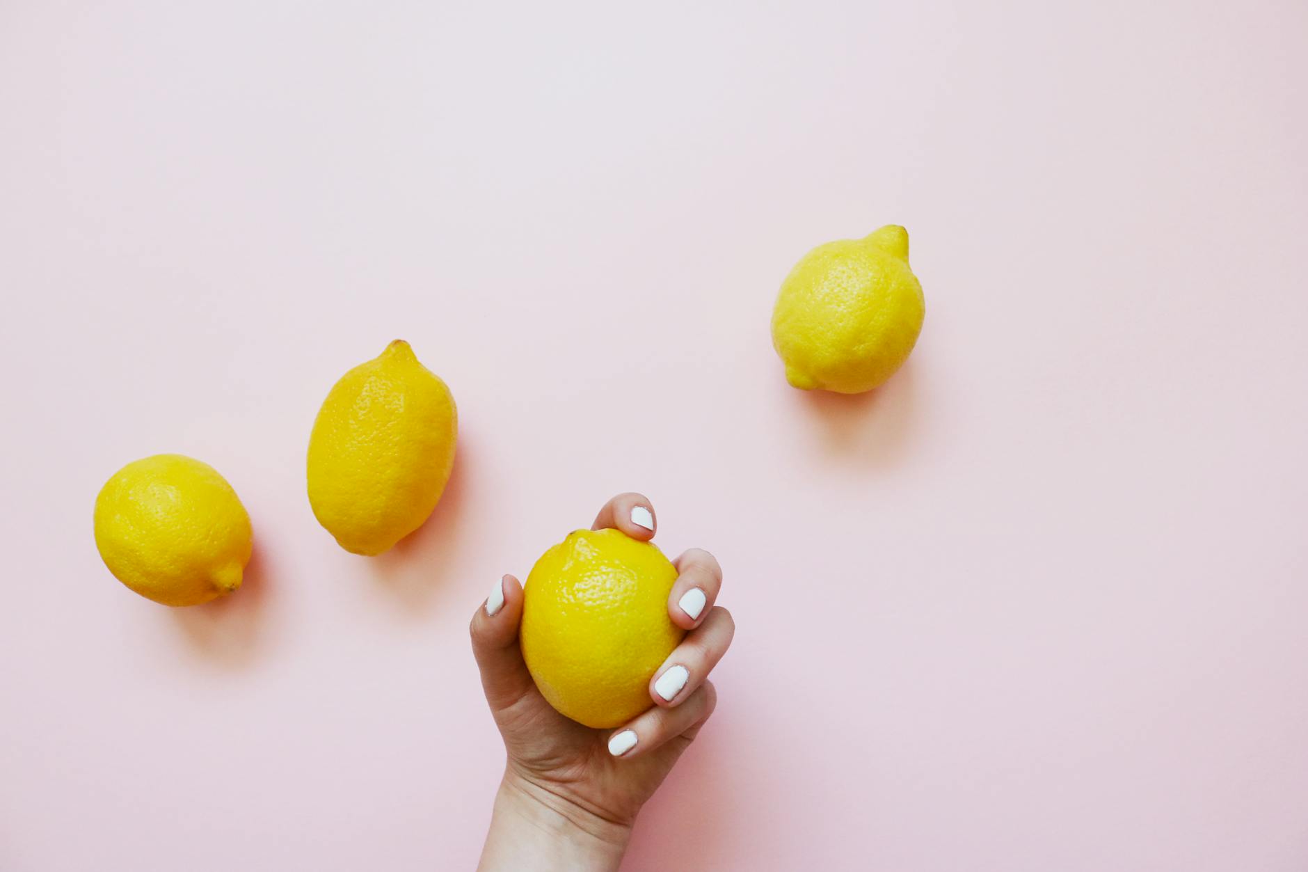 Fresh ripe lemons on a pastel background, symbolizing renewal and natural healing.