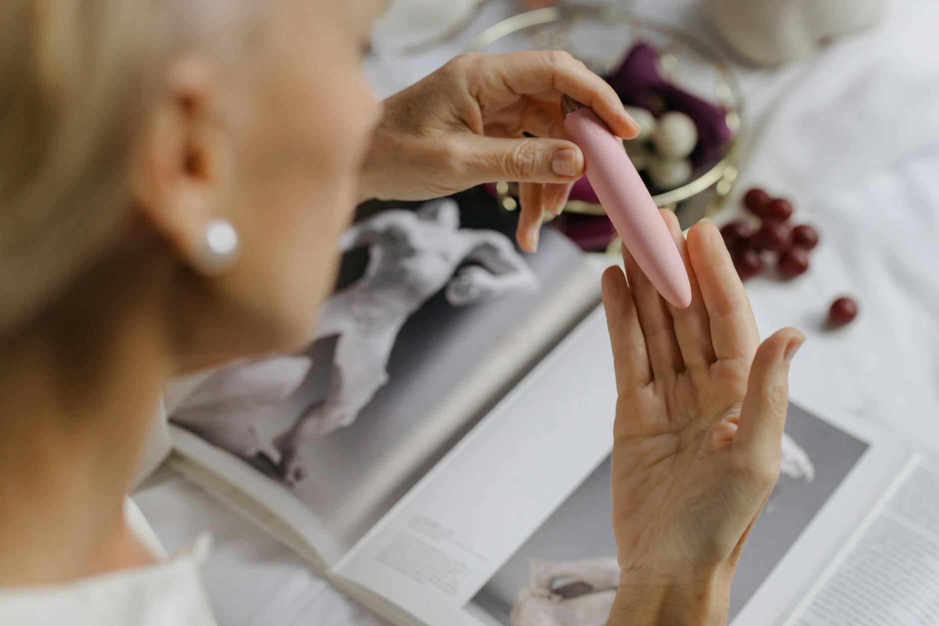 Close-up of a woman holding a pink vibrator, symbolizing intentional pleasure after medication changes