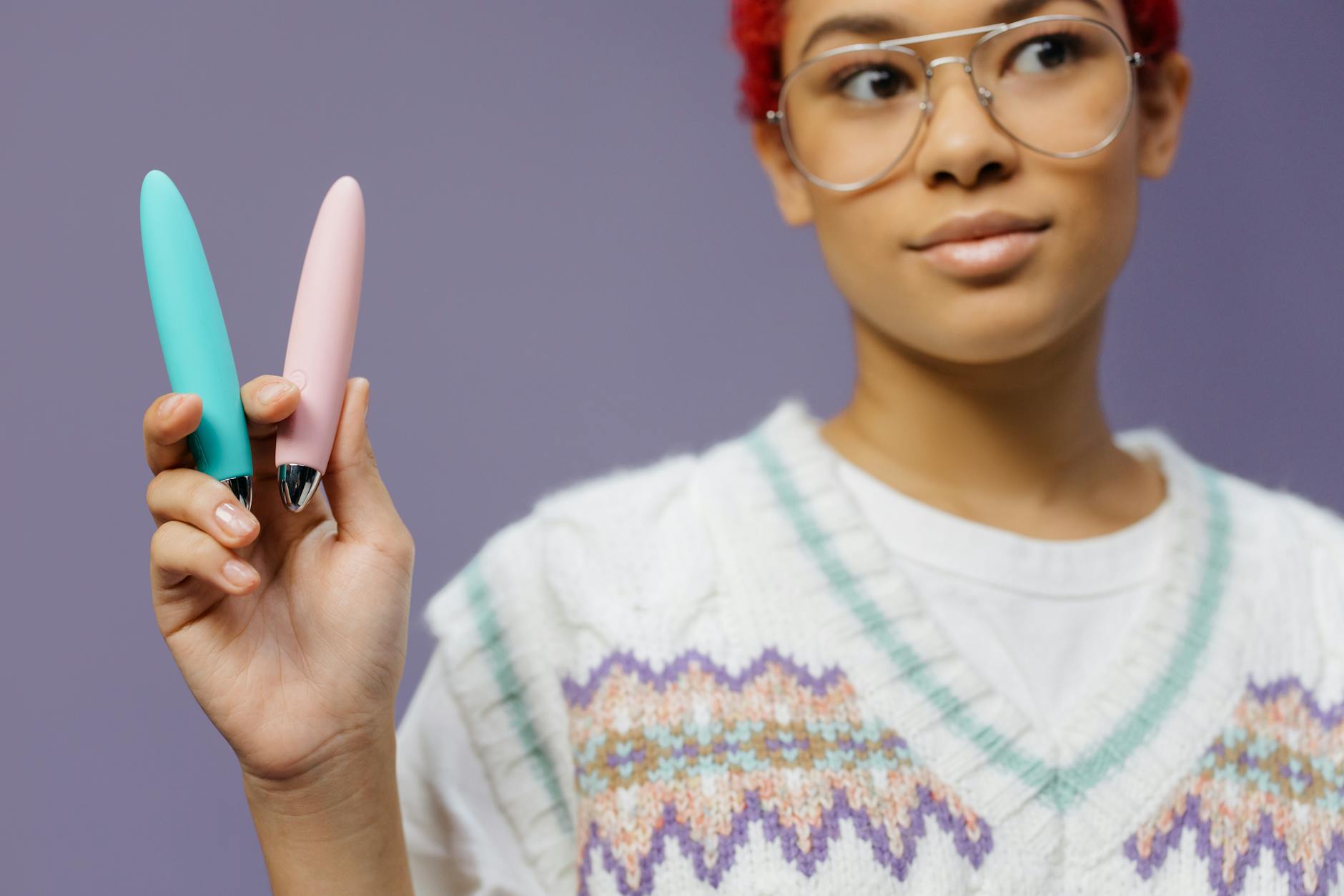 Colorful clitoral vibrators displayed against a purple background