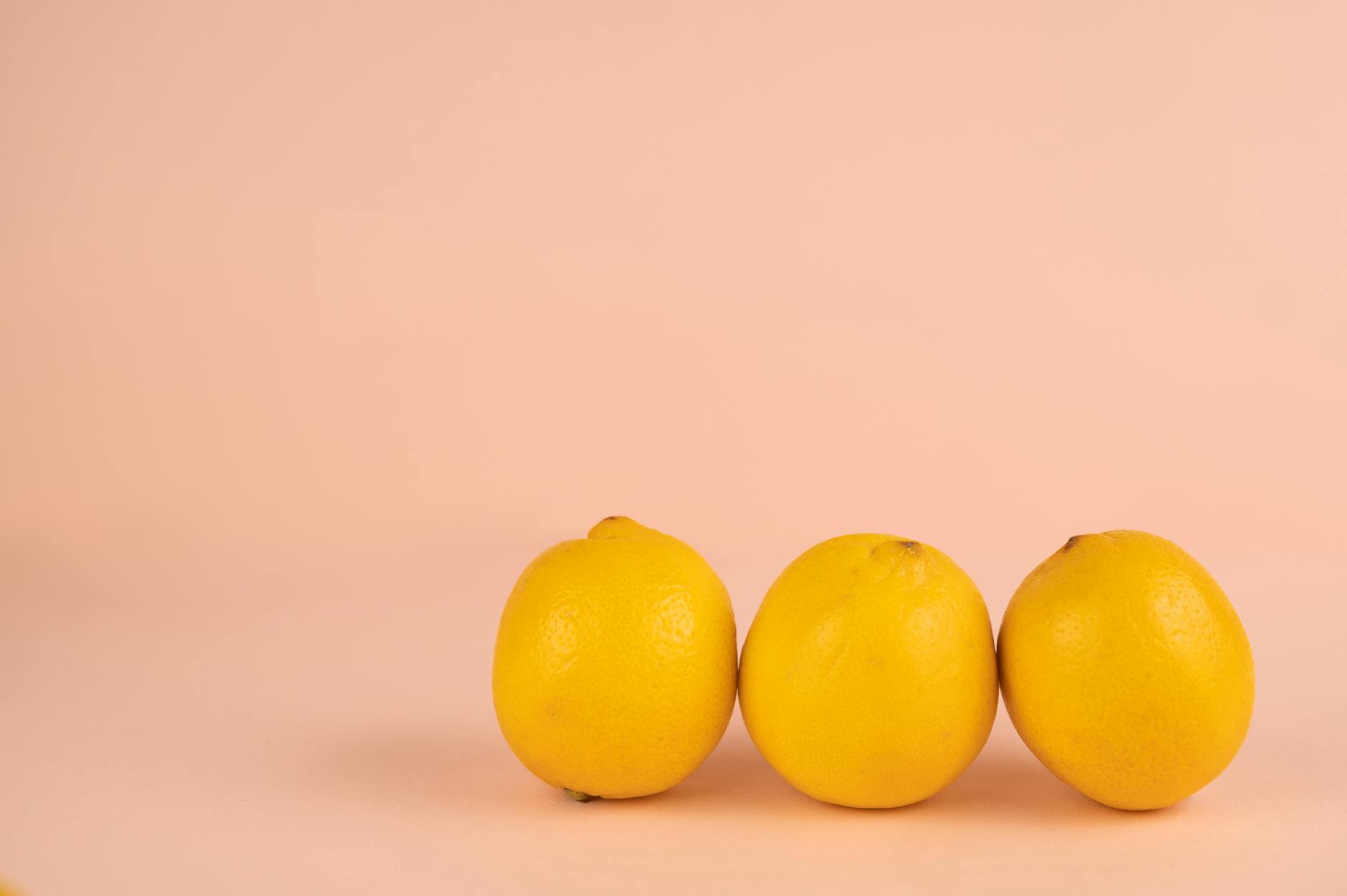 Bright ripe lemons on a pastel background, symbolizing fresh pleasure and renewal